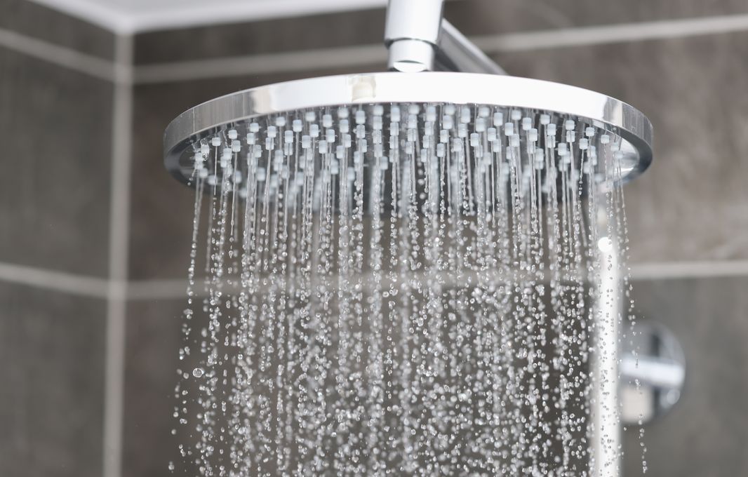 Water pouring from a chrome rain shower head