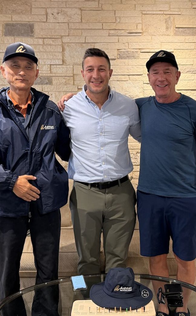 Three members of the Ashton family team smiling together