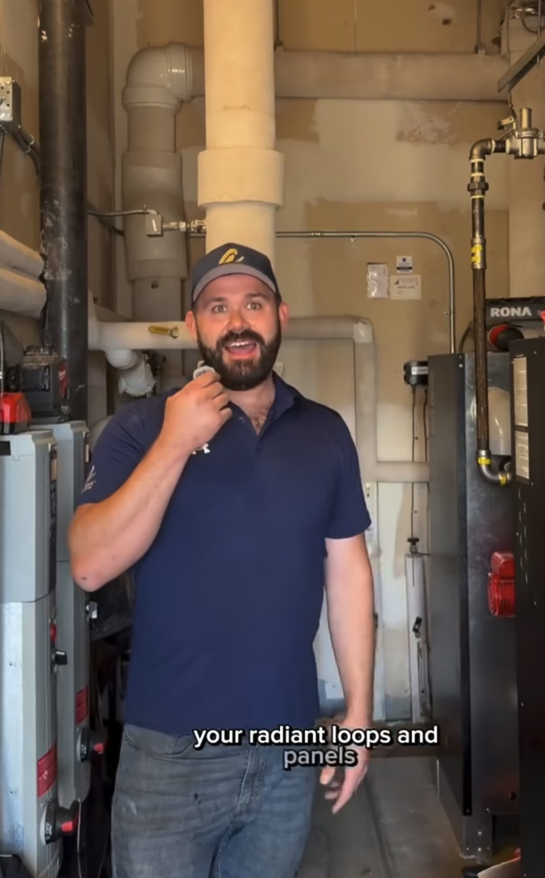 Ashton technician explaining a radiant heating system in a mechanical room