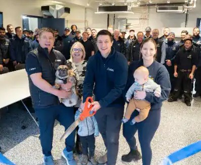 The Ashton family and team cutting the ribbon at the opening of the new shop